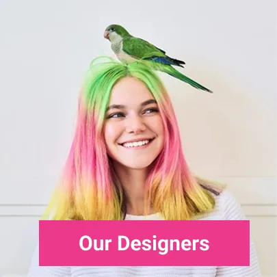 A smiling young woman with long, vibrant green, pink, and yellow hair, and a green parrot perched on her head. A pink banner at the bottom reads 'Our Designers'.