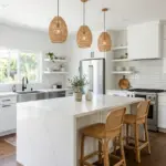 New kitchen with white shaker cabinets, a quartz island with stools, tile backsplash and woven pendant lights